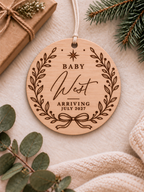 Personalised baby announcement ornament with botanical wreath, bow, baby name and expected arrival date