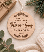 Personalised eucalyptus wood engagement Christmas ornament with couple names, year and Our First Christmas Engaged design