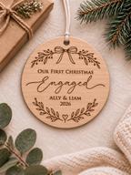 Personalised eucalyptus wood engagement Christmas ornament with couple names, year and Our First Christmas Engaged bow wreath design